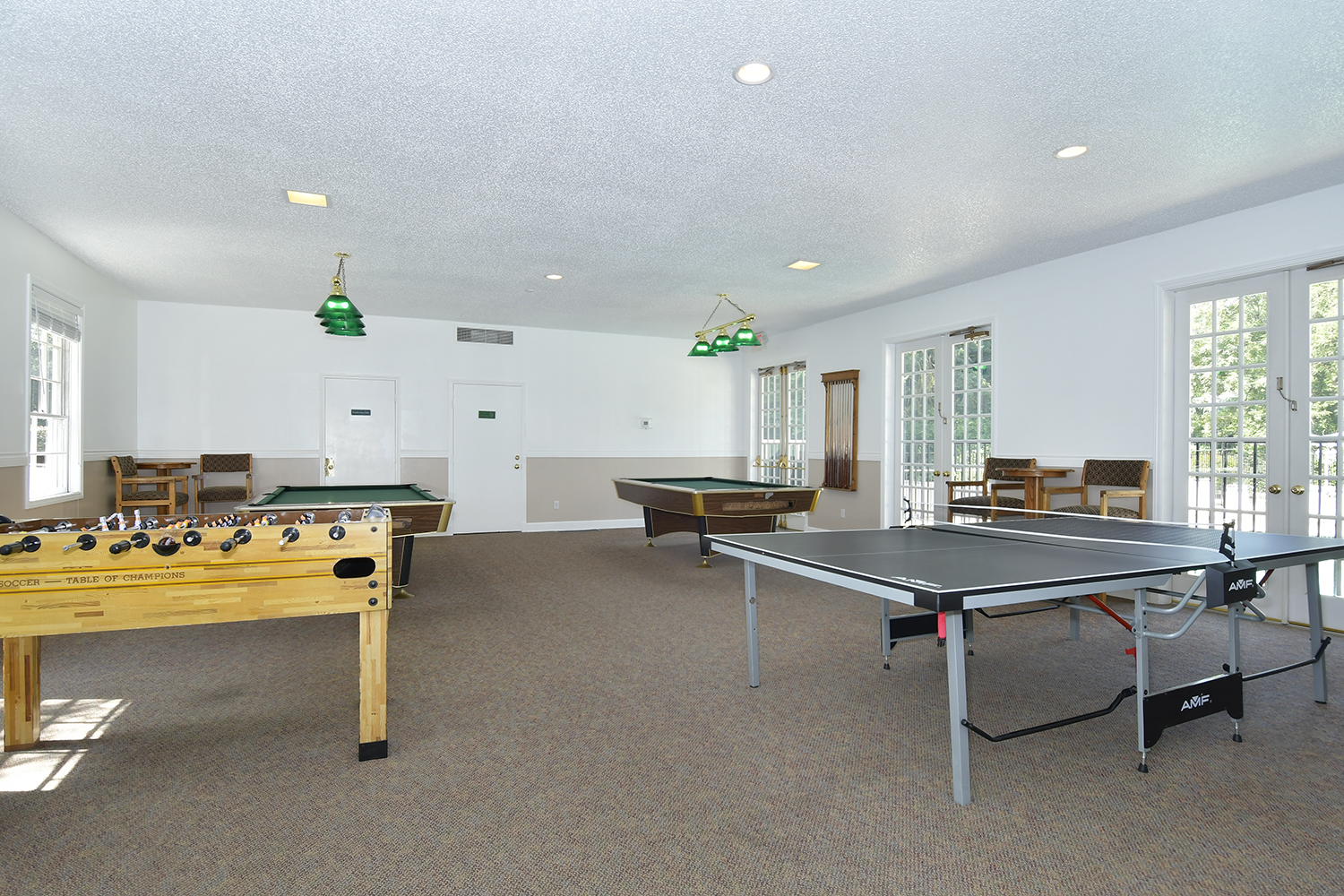 Game room with Foosball, ping pong and two pool tables.