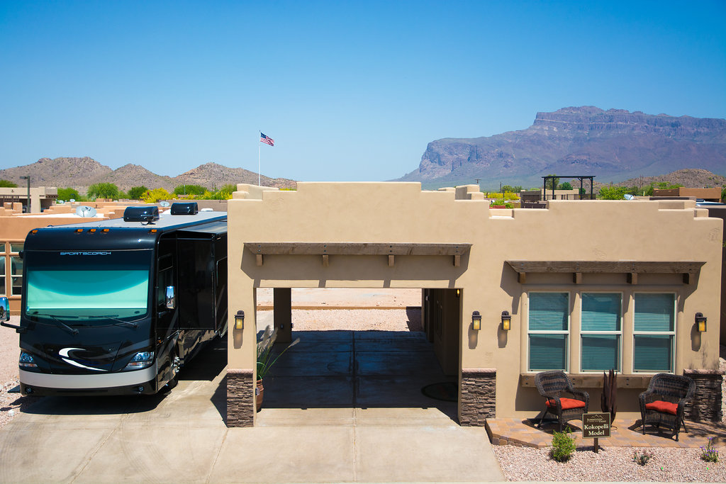 Beautiful beige colored manufactured home with large, connected carport. Beautiful view of the Superstition Mountains in the background.