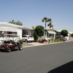 Street view of mobile-home community. Offers welcoming atmosphere with open streets accessible for all cars including resident owned golf carts.