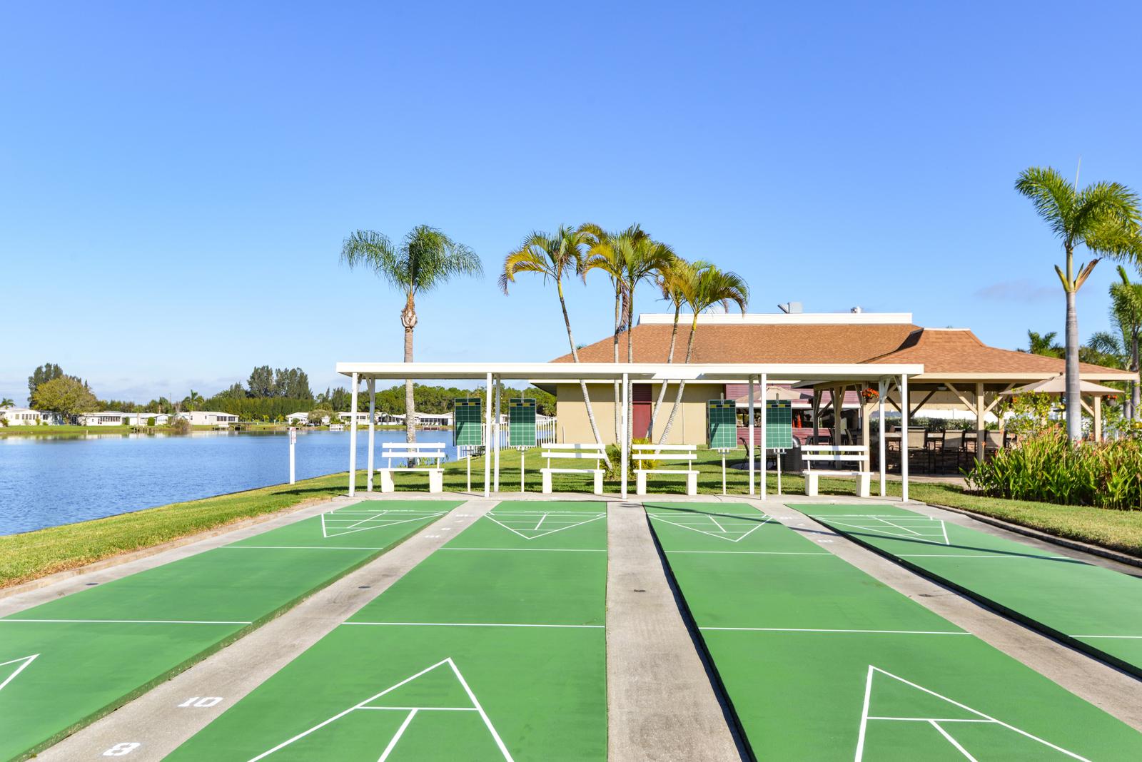 Four shuffleboard courts with covered seating. Sits next to lake.