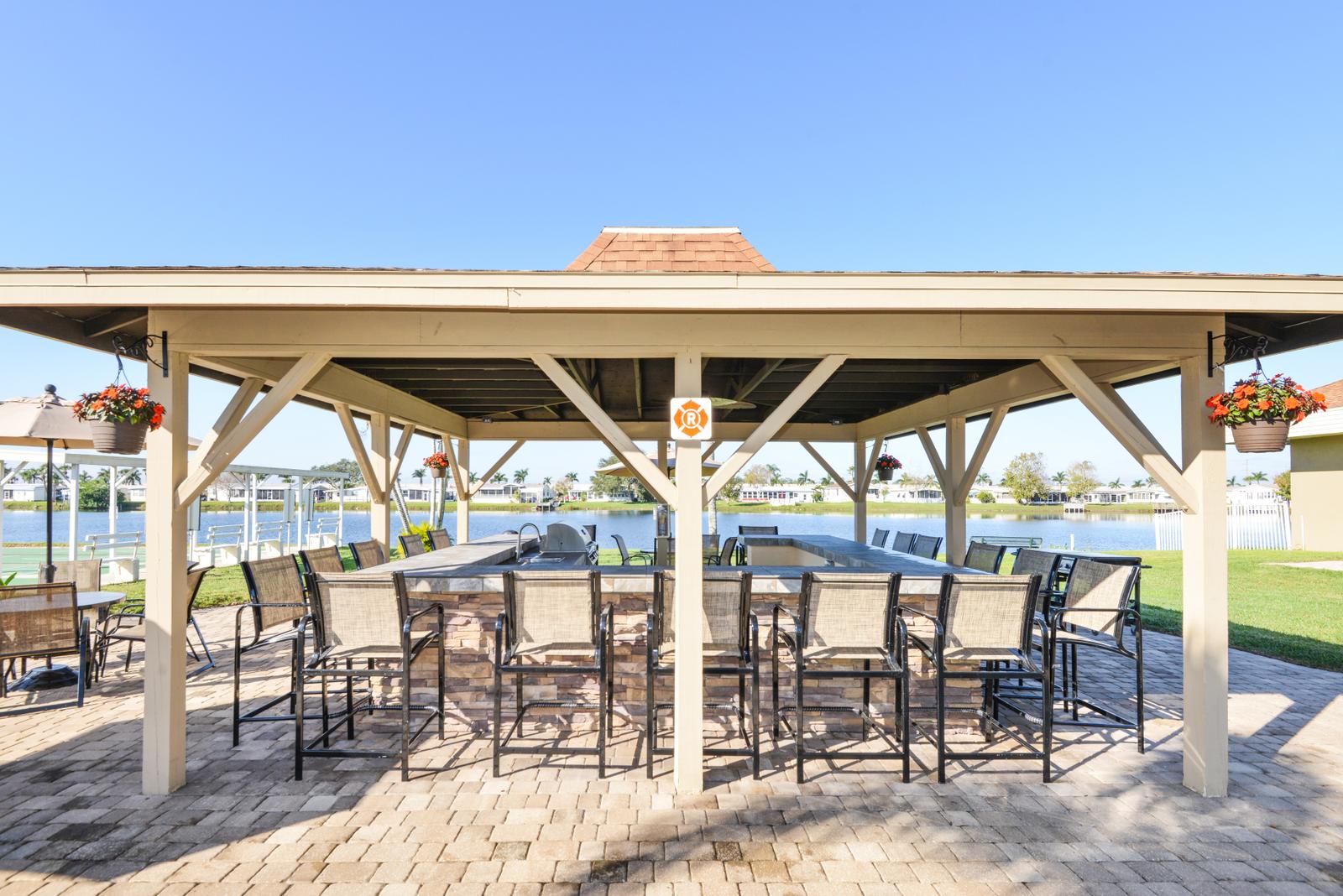 Large covered BBQ and patio area located outside off the lake.