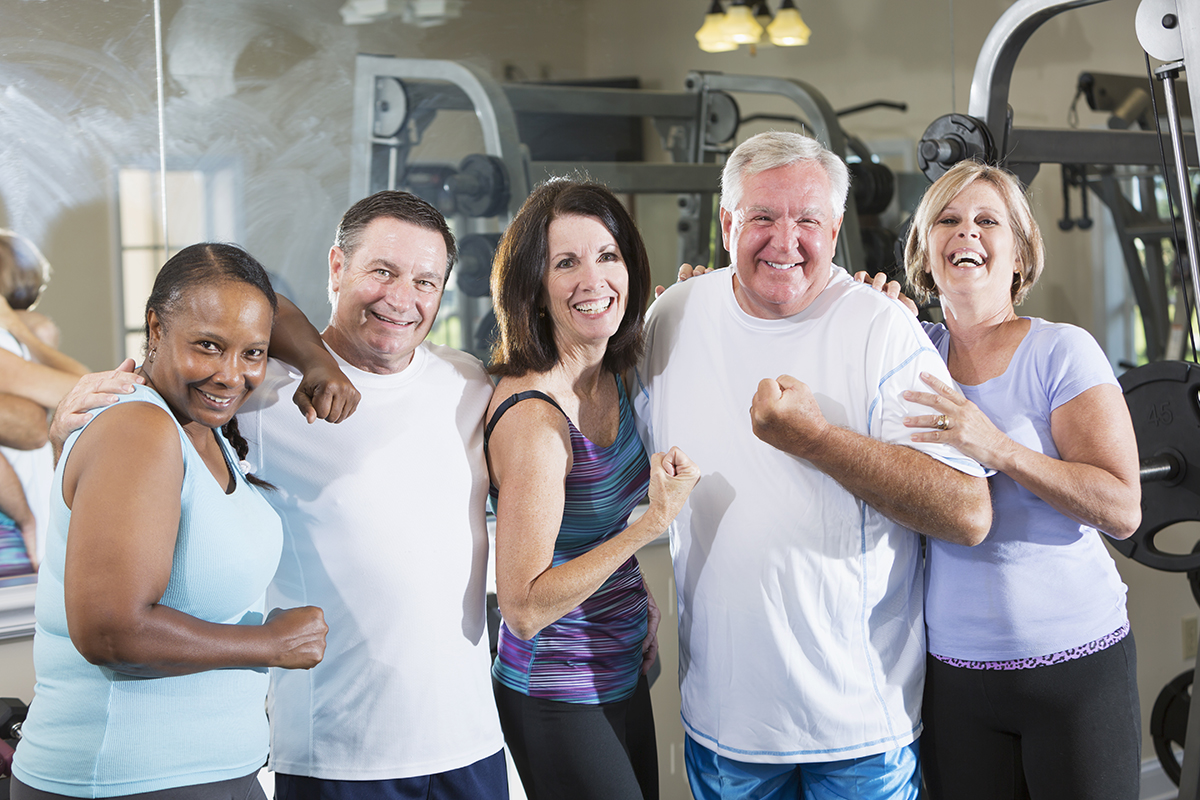 Multi-ethnic group of mature men and women (50s, 60s) staying fit, at the gym