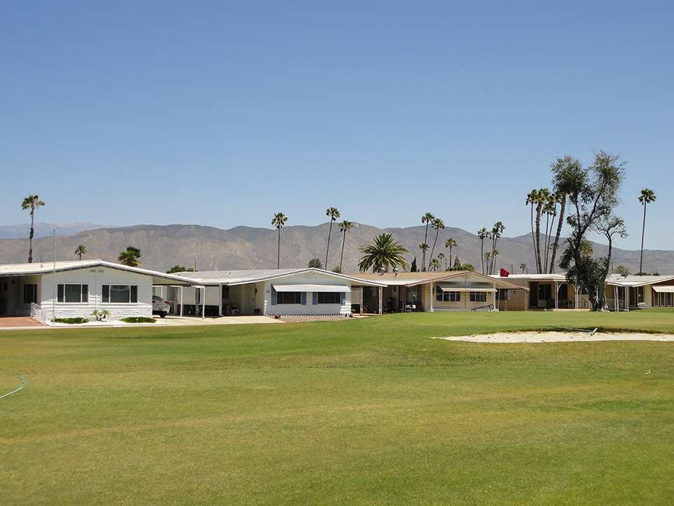 Beautiful, green golf course surrounding the multiple manufactured homes in the 55+ community. Residents have the luxury of two beautiful views, that of the mountains and of the golf course.