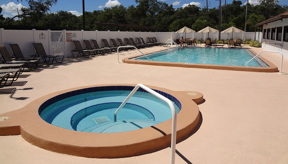 A spa sits near pool.