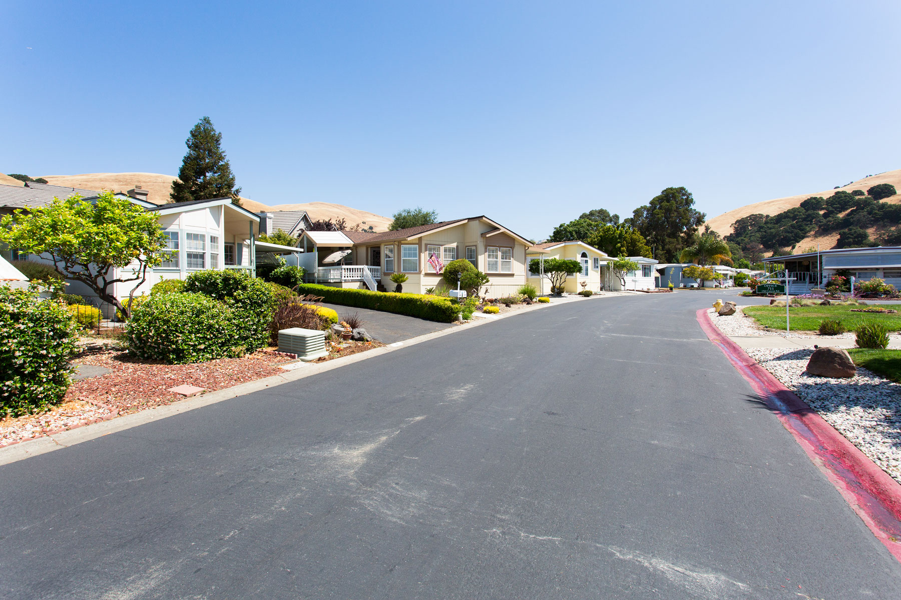 Beautiful manufactured homes line the wide, paved streets of the community. Each home has a unique character, with differing styles and front landscape.