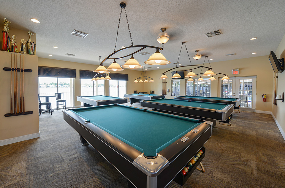 Quite large billiards room with five pool tables. Tvs mounted to wall. Plenty of lighting over each pool table.