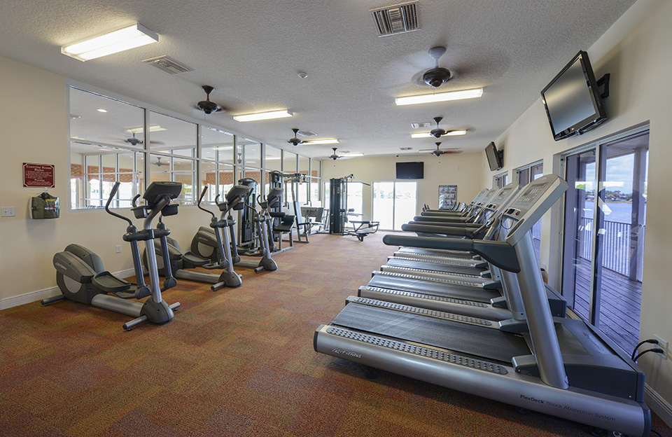 The fitness room has TVs mounted to wall for viewing while working out. There's treadmills and elliptical machines.
