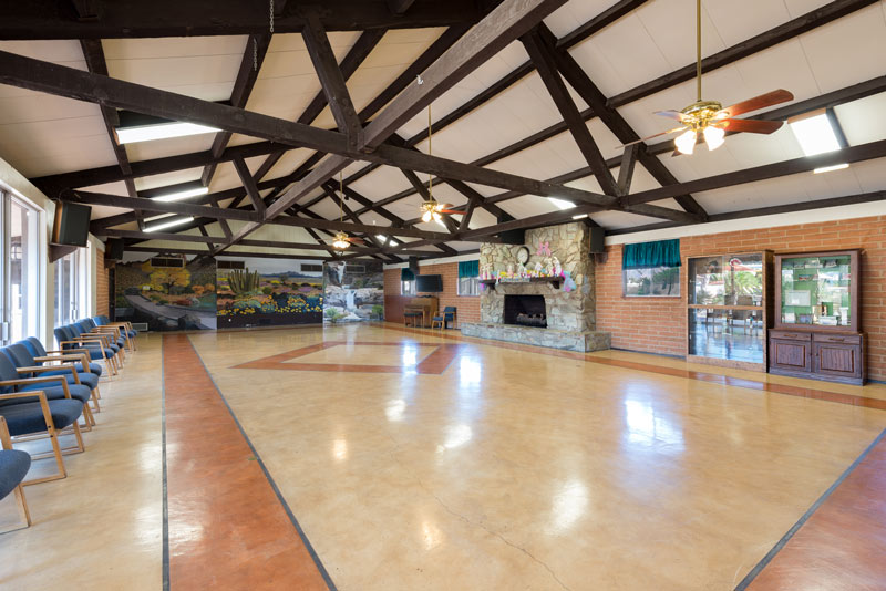 Large, open community center space with high vaulted ceilings. Space for residents to host events or community activities.