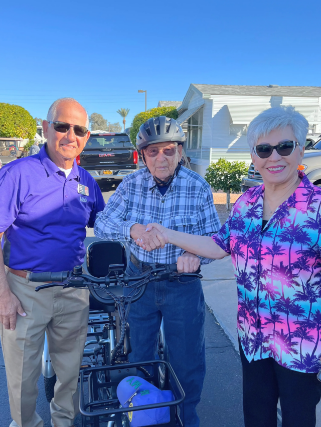 Mesa Regal Resident with managers pet friendly man hands out treats